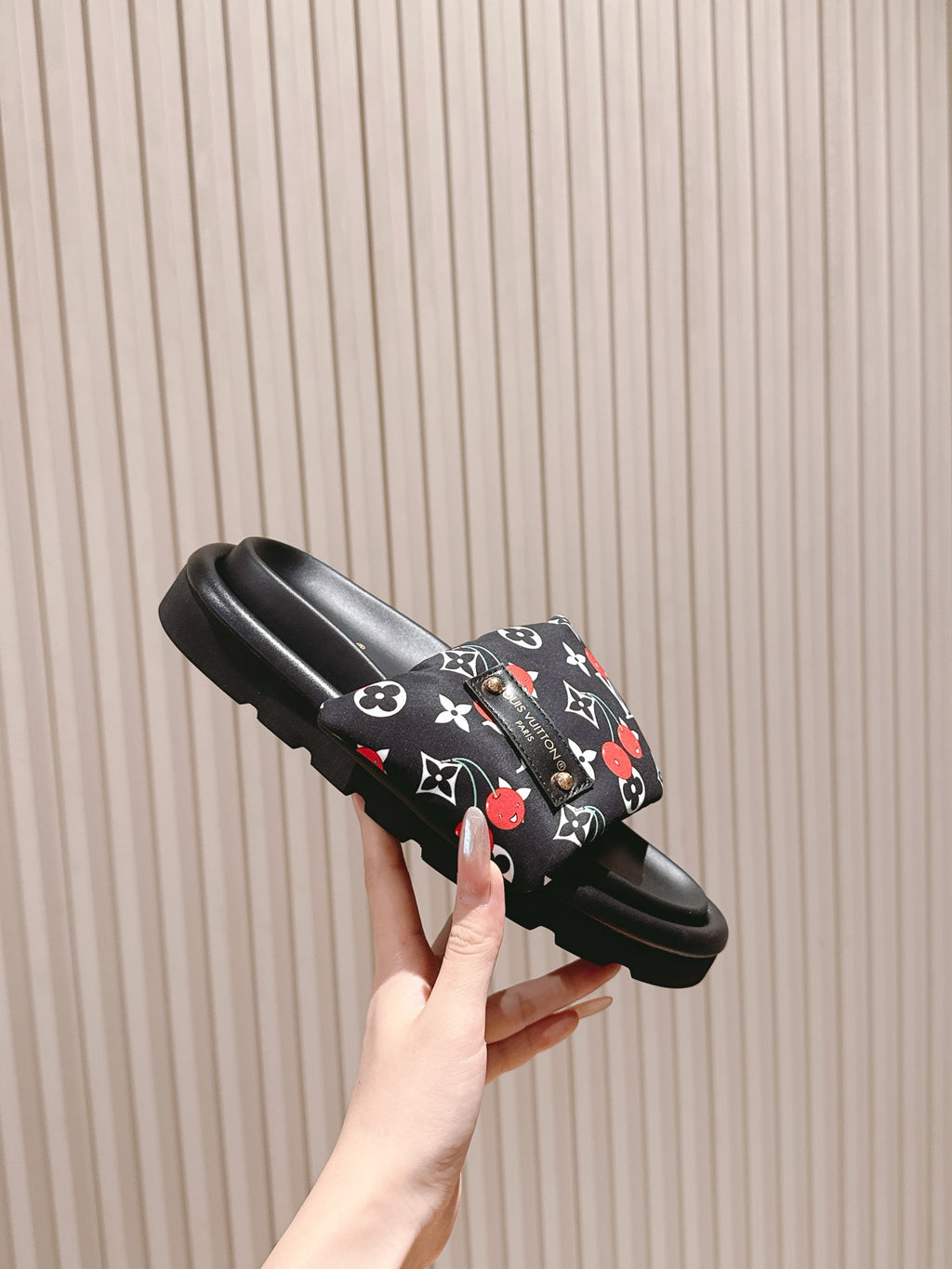 Louis Vuitton slide sandal, black with multicolor monogram strap and platform sole.