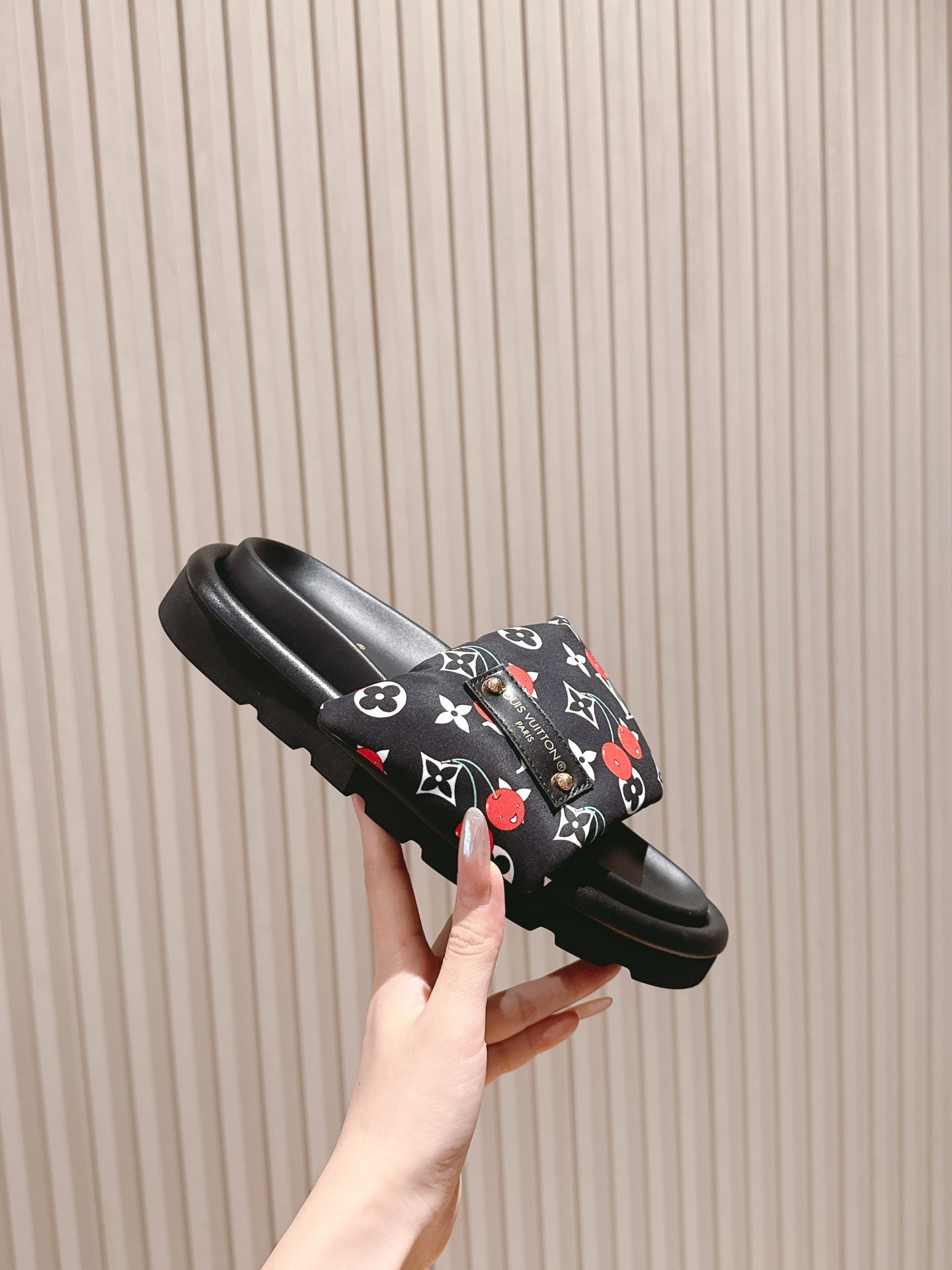 Louis Vuitton slide sandal, black with multicolor monogram strap and platform sole.