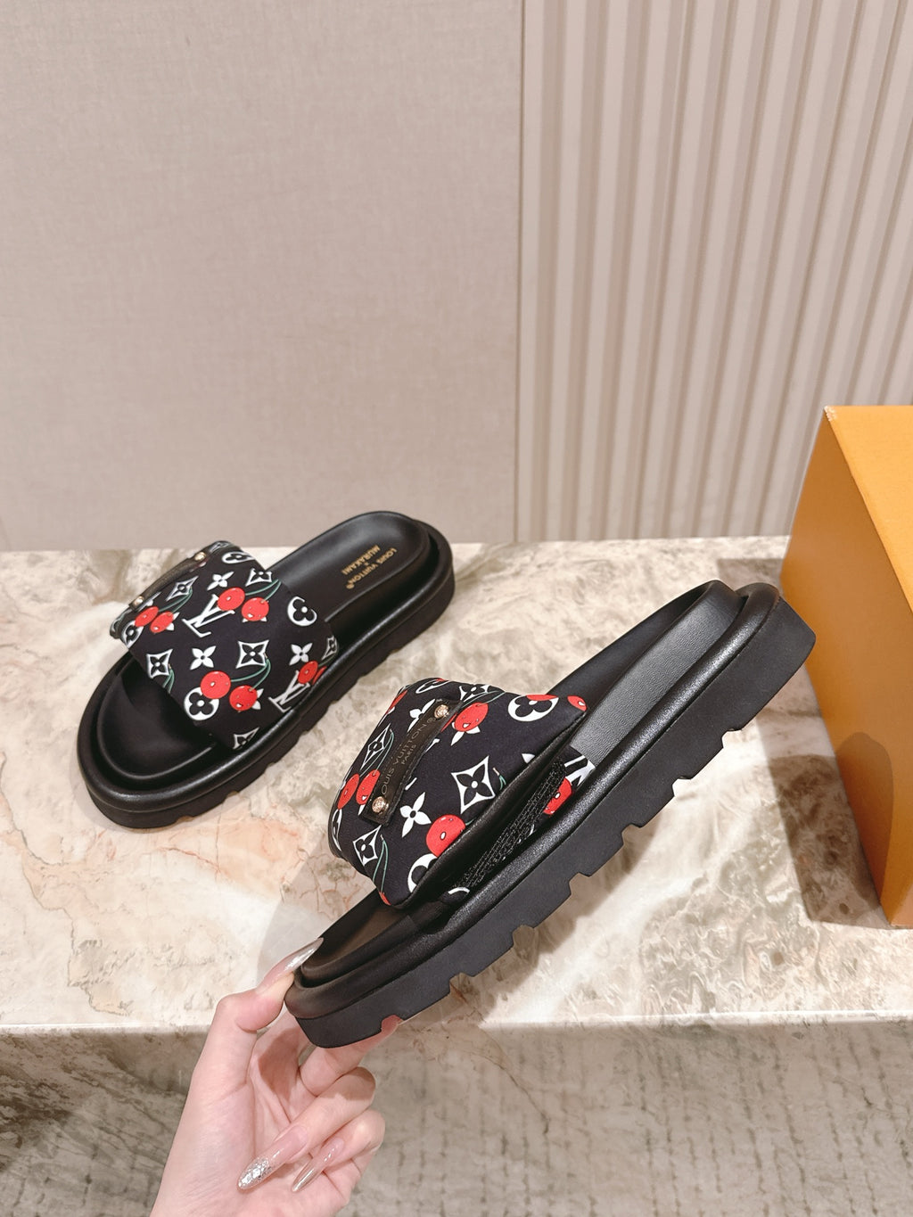 Louis Vuitton slide sandals, black with multicolor monogram strap and rugged sole.