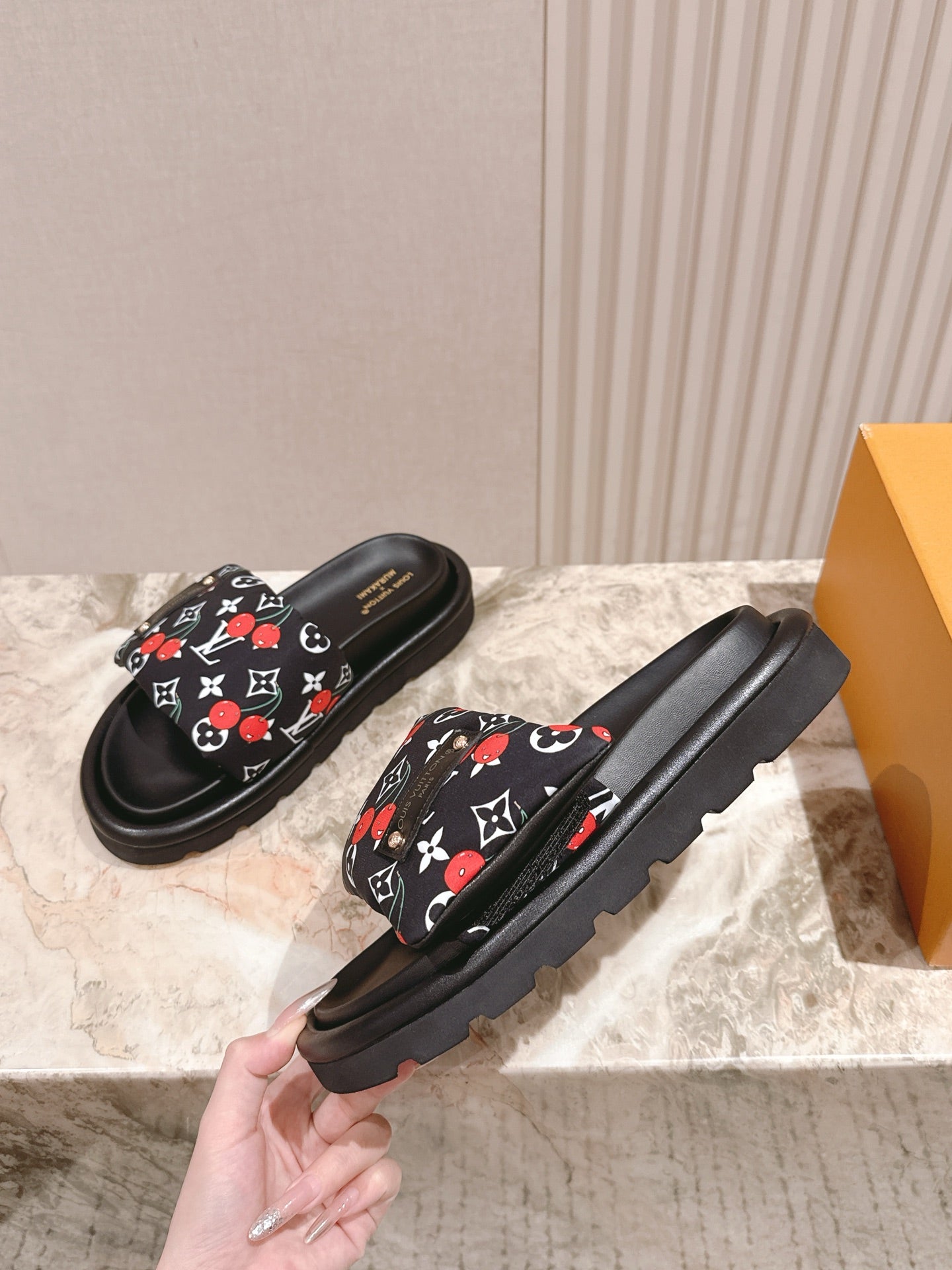 Louis Vuitton slide sandals, black with multicolor monogram strap and rugged sole.