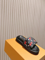 Louis Vuitton slide sandal, black with multicolor monogram strap and cushioned sole.