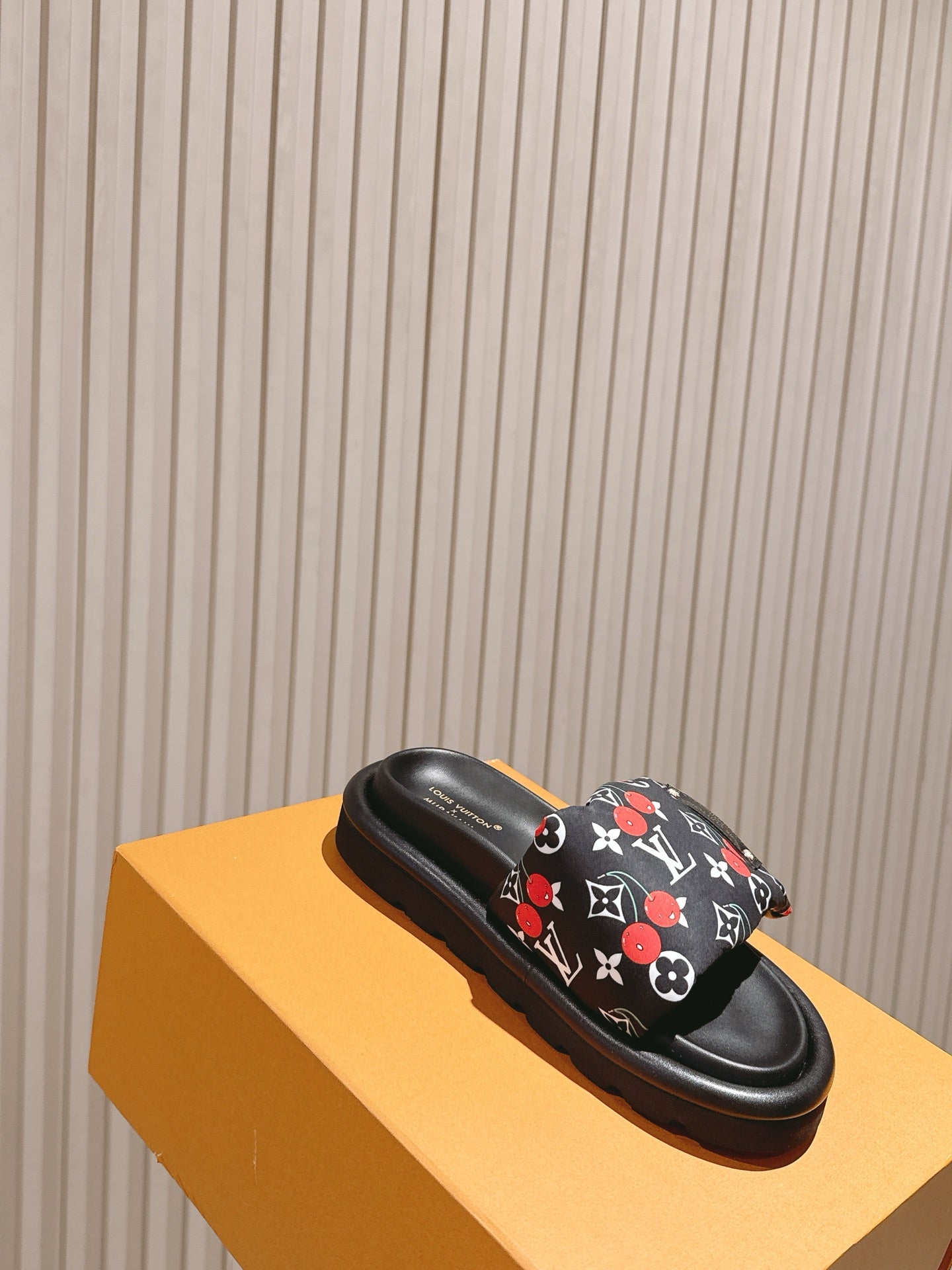 Louis Vuitton slide sandal, black with multicolor monogram strap and cushioned sole.