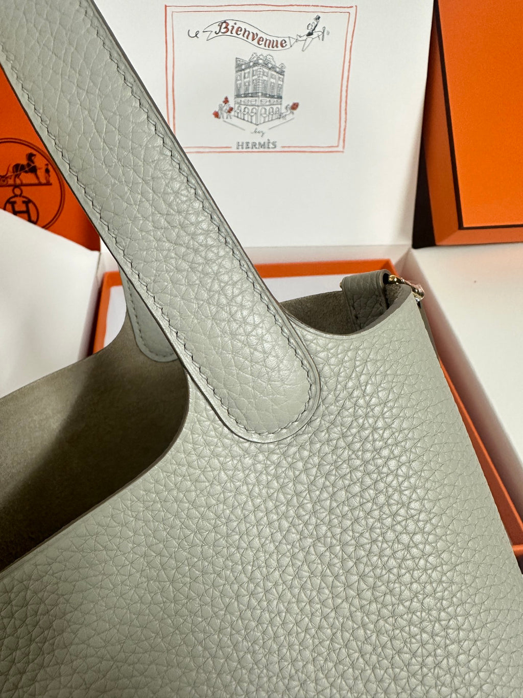 Hermes pale gray leather tote bag strap close-up with textured grain