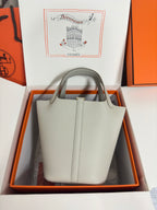 Hermes pale gray structured tote bag with two top handles, displayed in box