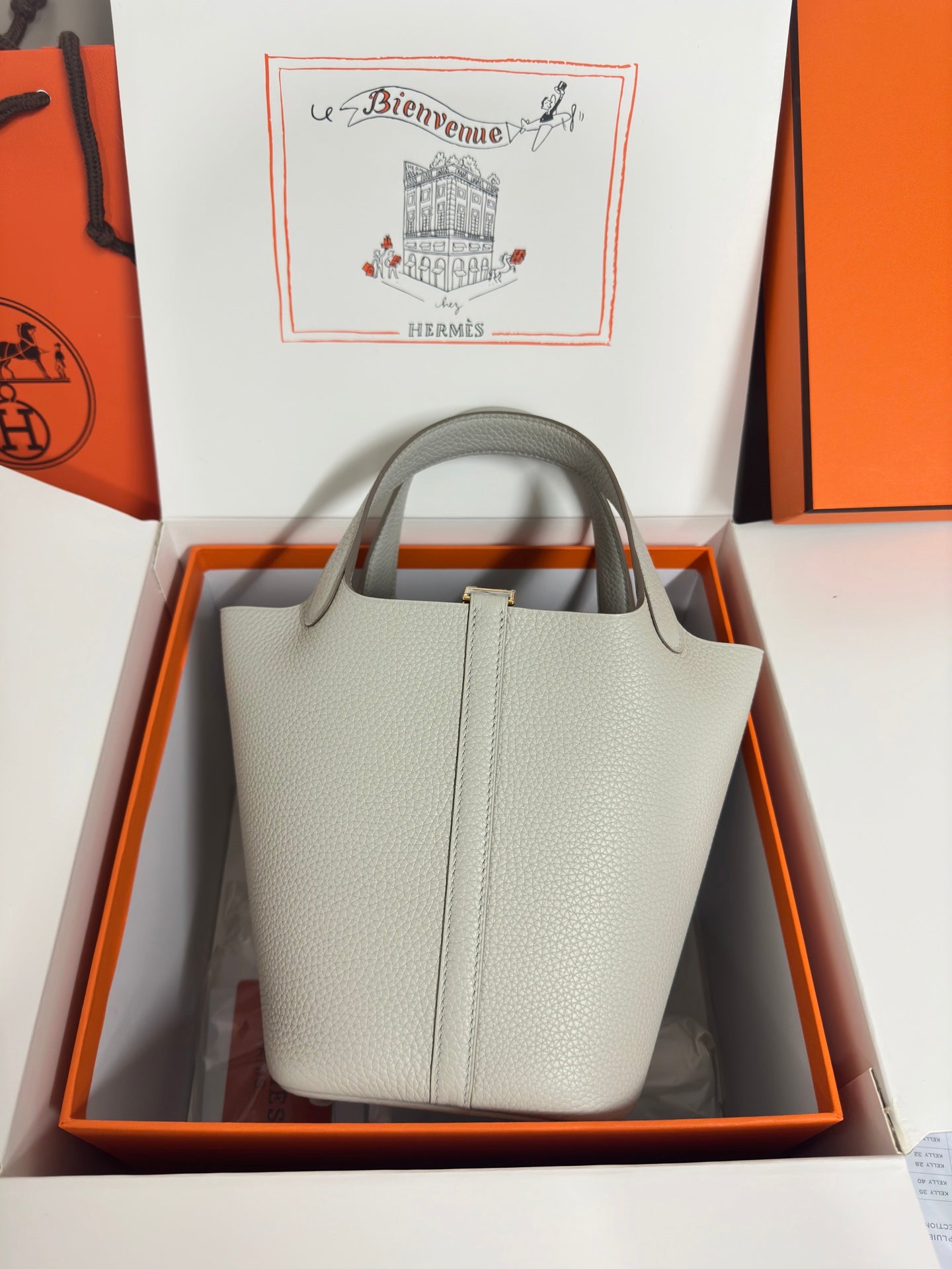 Hermes pale gray structured tote bag with two top handles, displayed in box