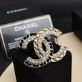 Jeweled gold-tone brooch with pearls and clear crystals, curved interlocking C shape