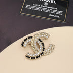 Gold-tone brooch with pearls and clear crystals, curved interlocking C design