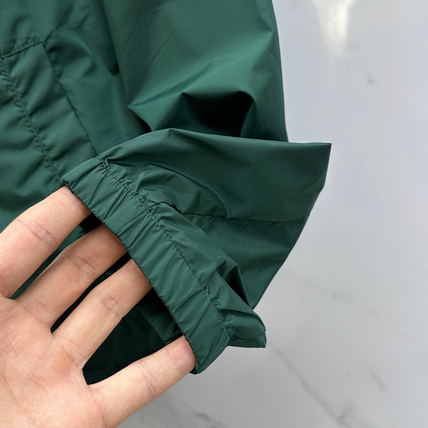Prada Re-Nylon hooded jacket, dark green sleeve cuff detail with gathered seam