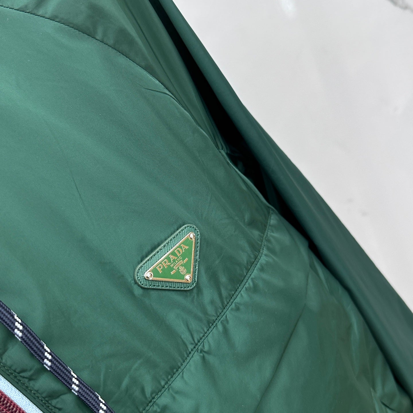 Prada Re-Nylon jacket, dark green with embroidered triangular Prada logo patch