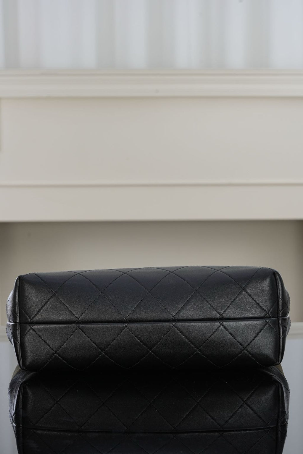 Black quilted shoulder bag with double-panel design and sleek top clasp