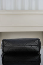 Black quilted shoulder bag with double-panel design and sleek top clasp