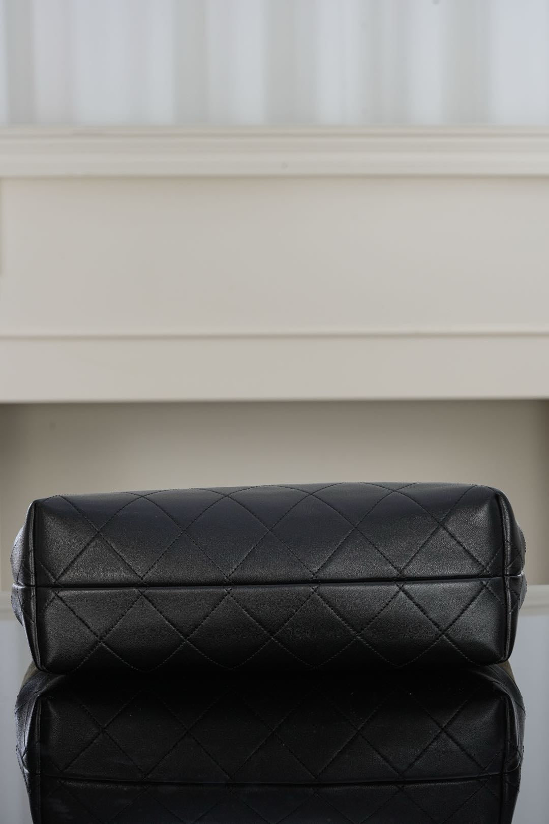 Black quilted shoulder bag with double-panel design and sleek top clasp