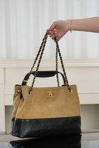 Bicolor quilted shoulder bag with chain handles, gold-tone logo, front view
