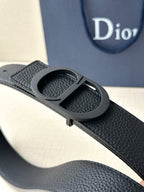 Black textured leather belt with CD buckle close-up