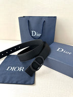Black leather Dior belt with CD buckle, shown with matching dust bag
