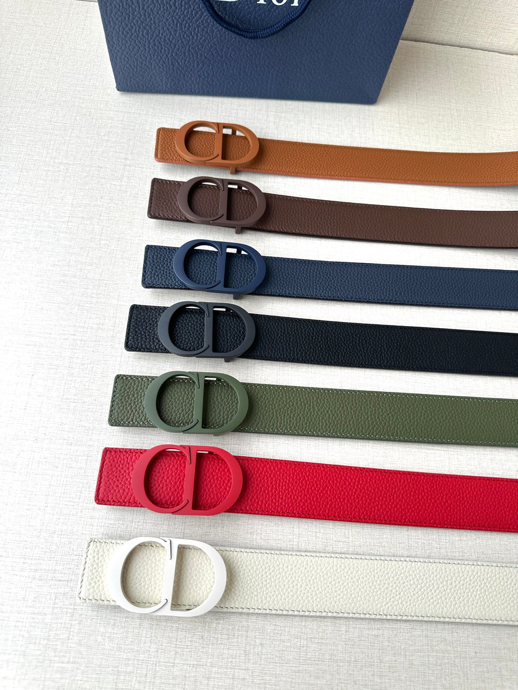 Dior belts set in multiple colors: orange, brown, blue, green, red, white