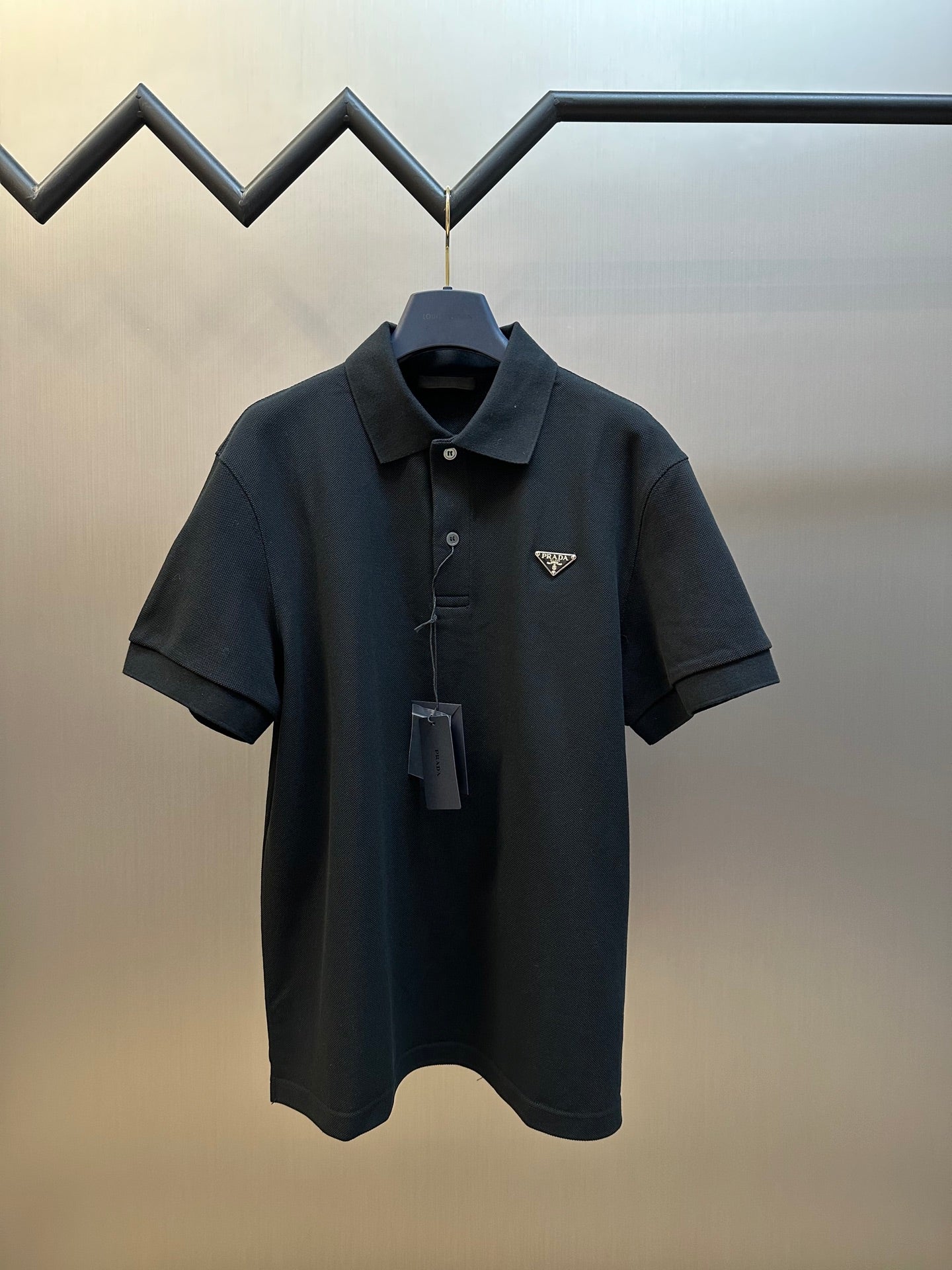 Prada dark short-sleeve polo shirt with buttoned collar and logo patch