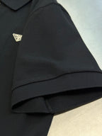 Prada dark polo shirt sleeve cuff with triangular logo patch