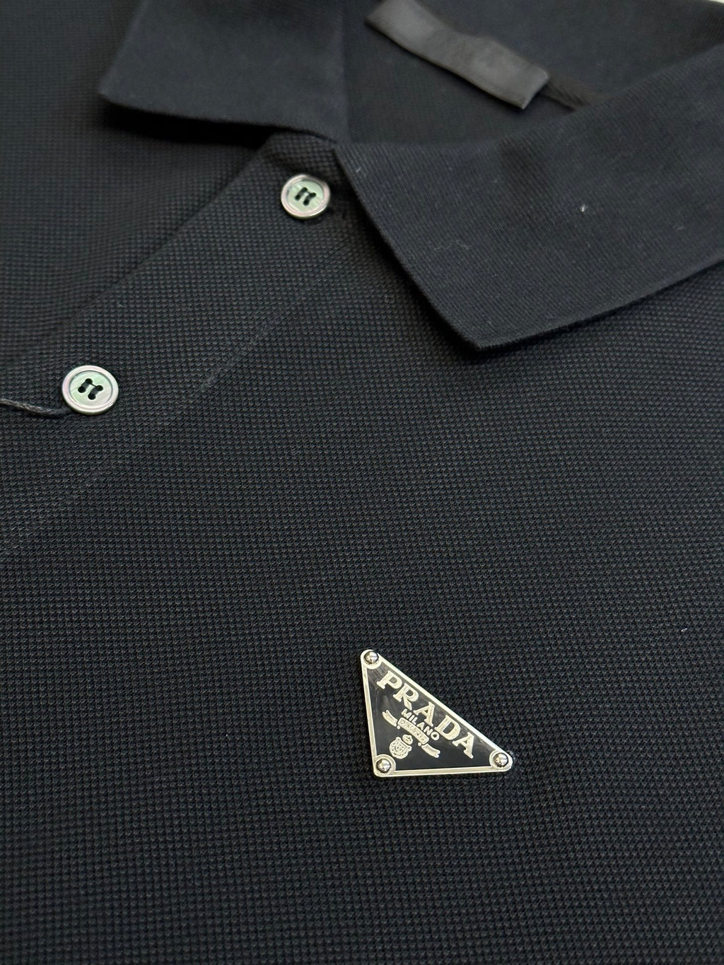 Prada dark polo shirt front detail with logo patch and button placket