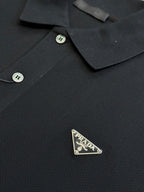 Prada polo shirt chest logo patch on dark textured fabric with buttoned placket