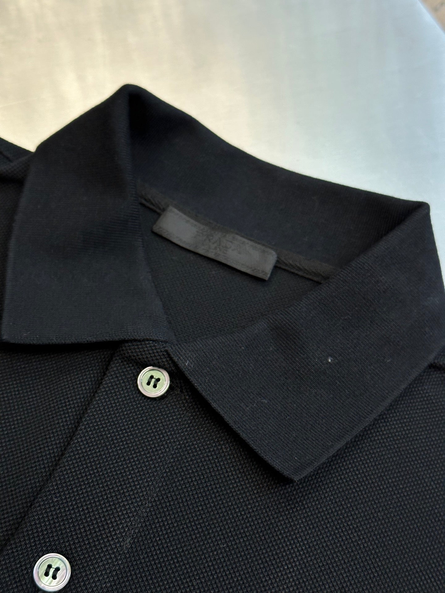 Prada polo shirt collar and button placket detail with small round buttons