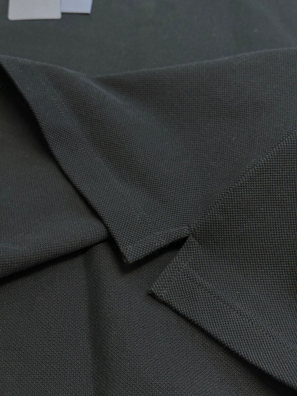 Prada dark polo shirt fabric and button placket detail