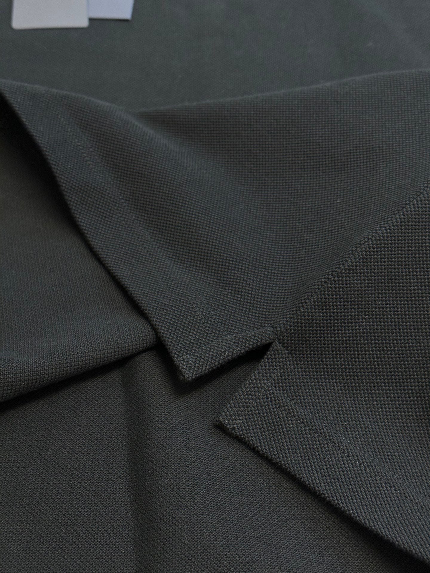 Prada dark polo shirt fabric and button placket detail