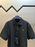 Prada dark polo shirt with spread collar, buttons, and triangular logo