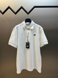 White polo shirt with short sleeves, button placket, and pointed logo badge