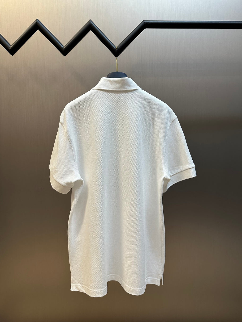 White Prada polo shirt back view with short sleeves and ribbed stand collar.