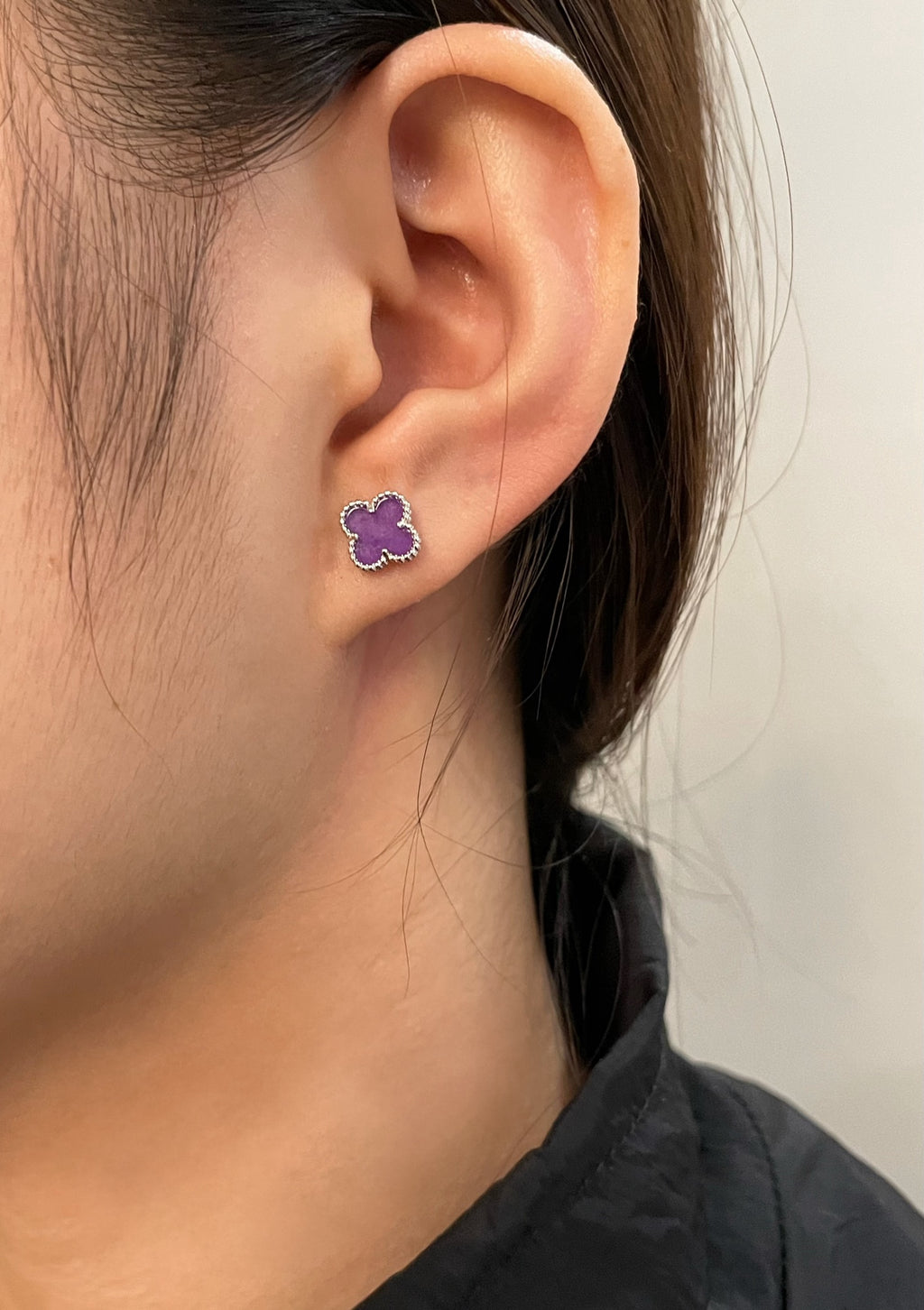 Purple clover stud earring on ear with silver-tone backing