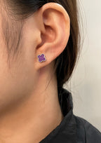 Purple clover stud earring on ear with silver-tone backing