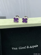 Purple clover stud earrings resting on Van Cleef & Arpels case