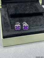 Purple clover stud earrings with silver-tone frames in jewelry box