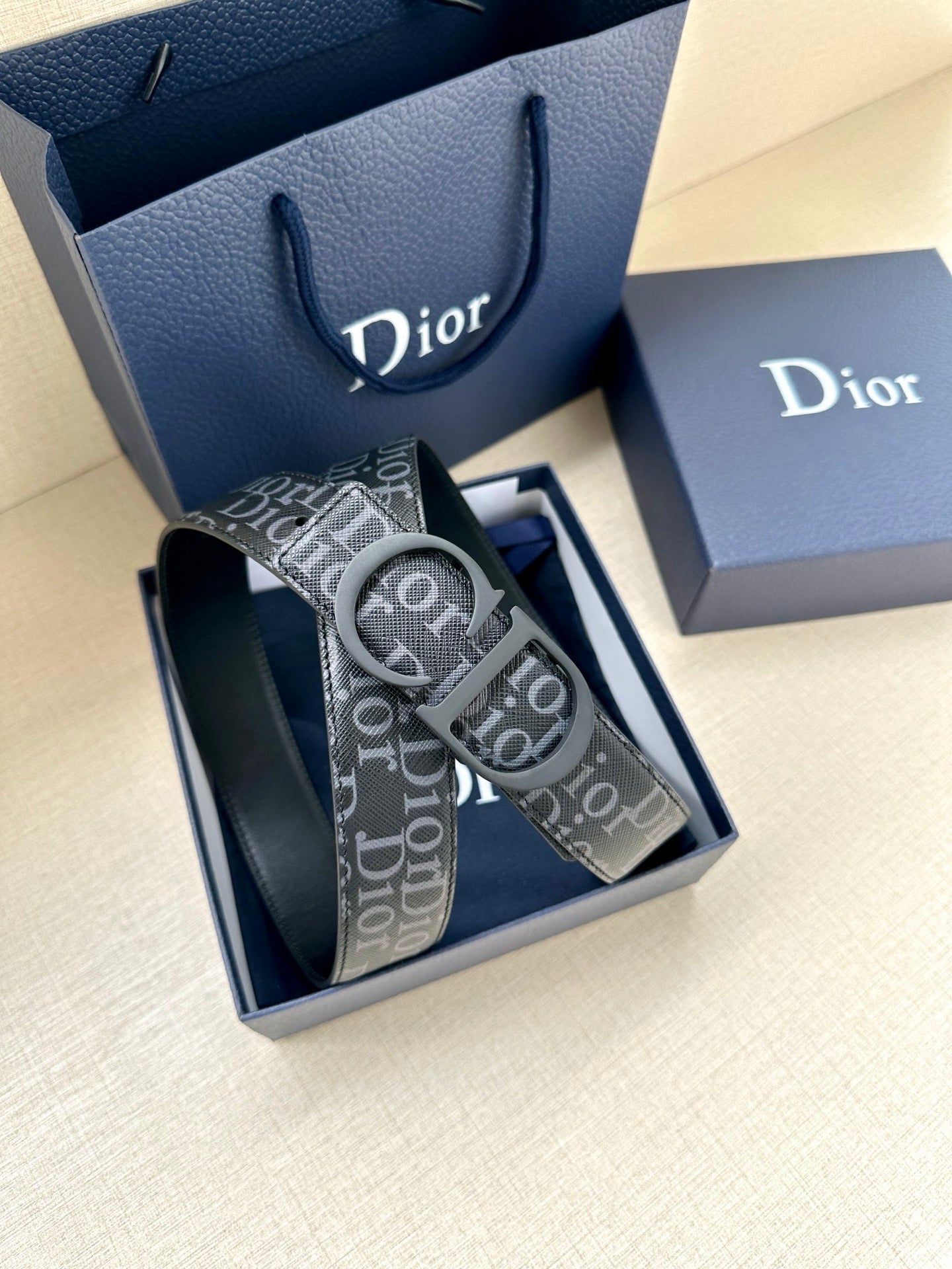 Black Dior monogram belt with oversized logo buckle and textured strap detail