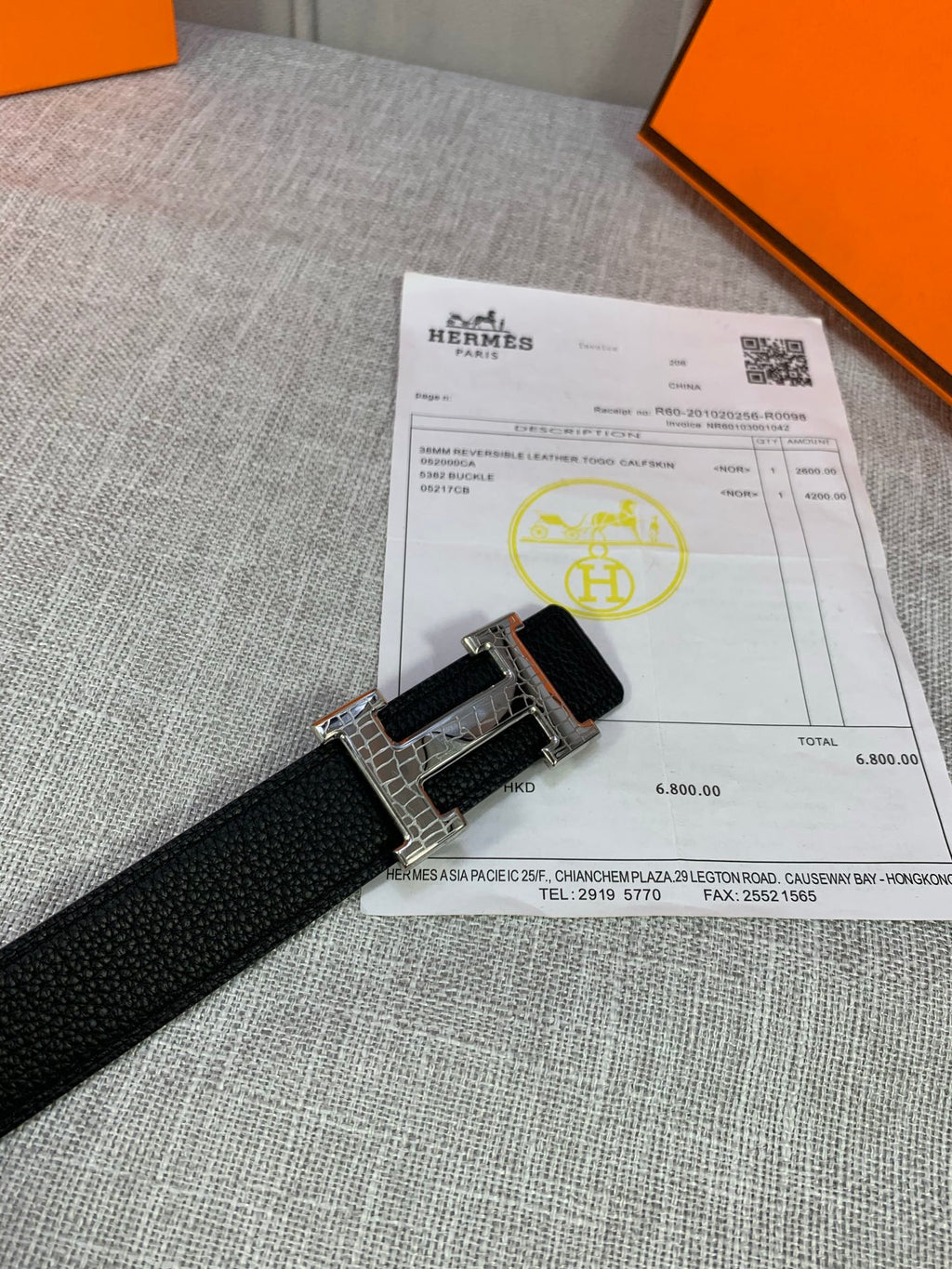Black textured leather belt with silver-tone buckle and keeper strap