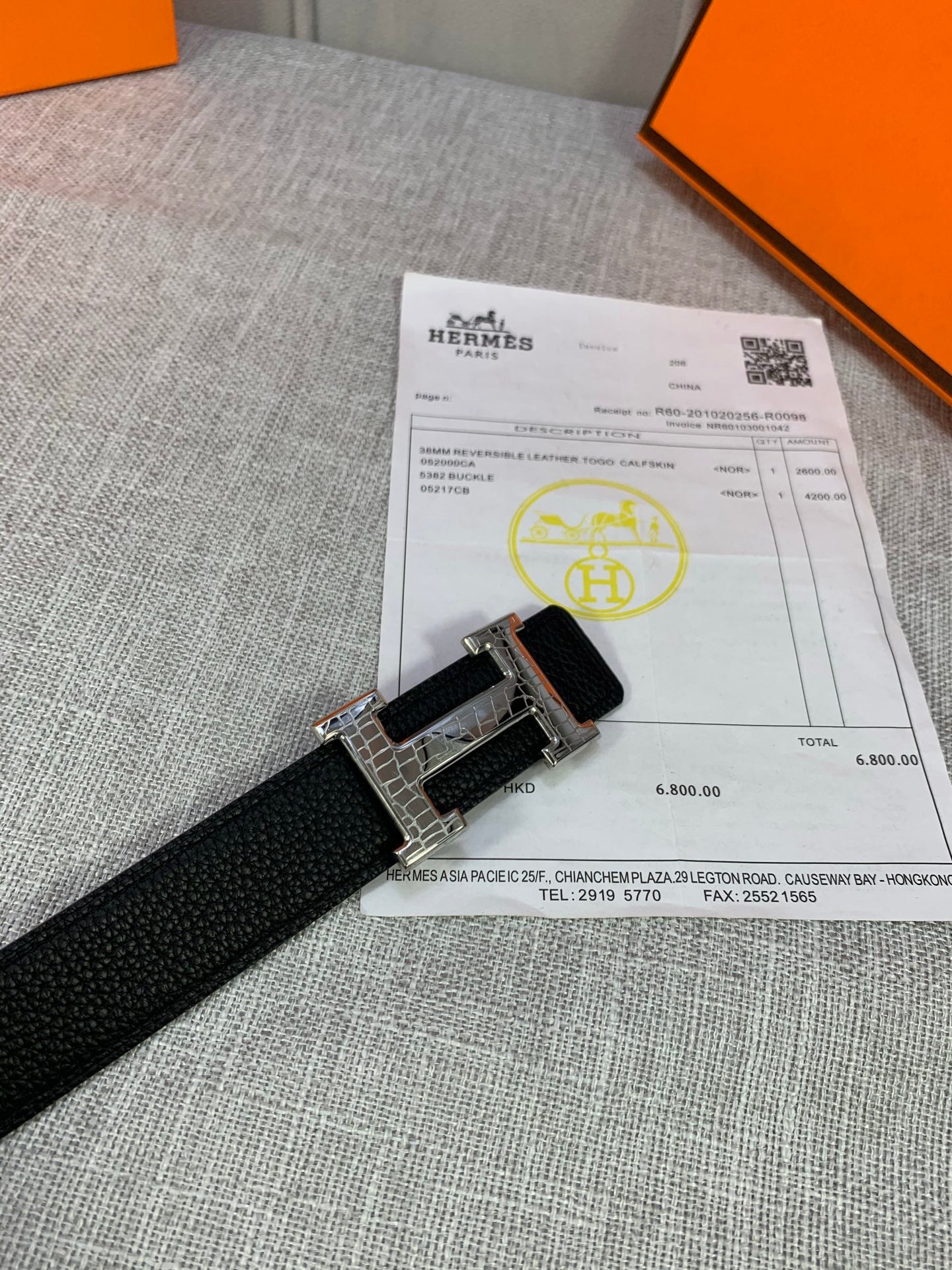 Black textured leather belt with silver-tone buckle and keeper strap