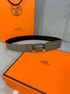 Olive leather belt with silver-toned square buckle, laid flat.