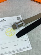 Olive leather belt detail: silver buckle with adjustable holes on the strap.