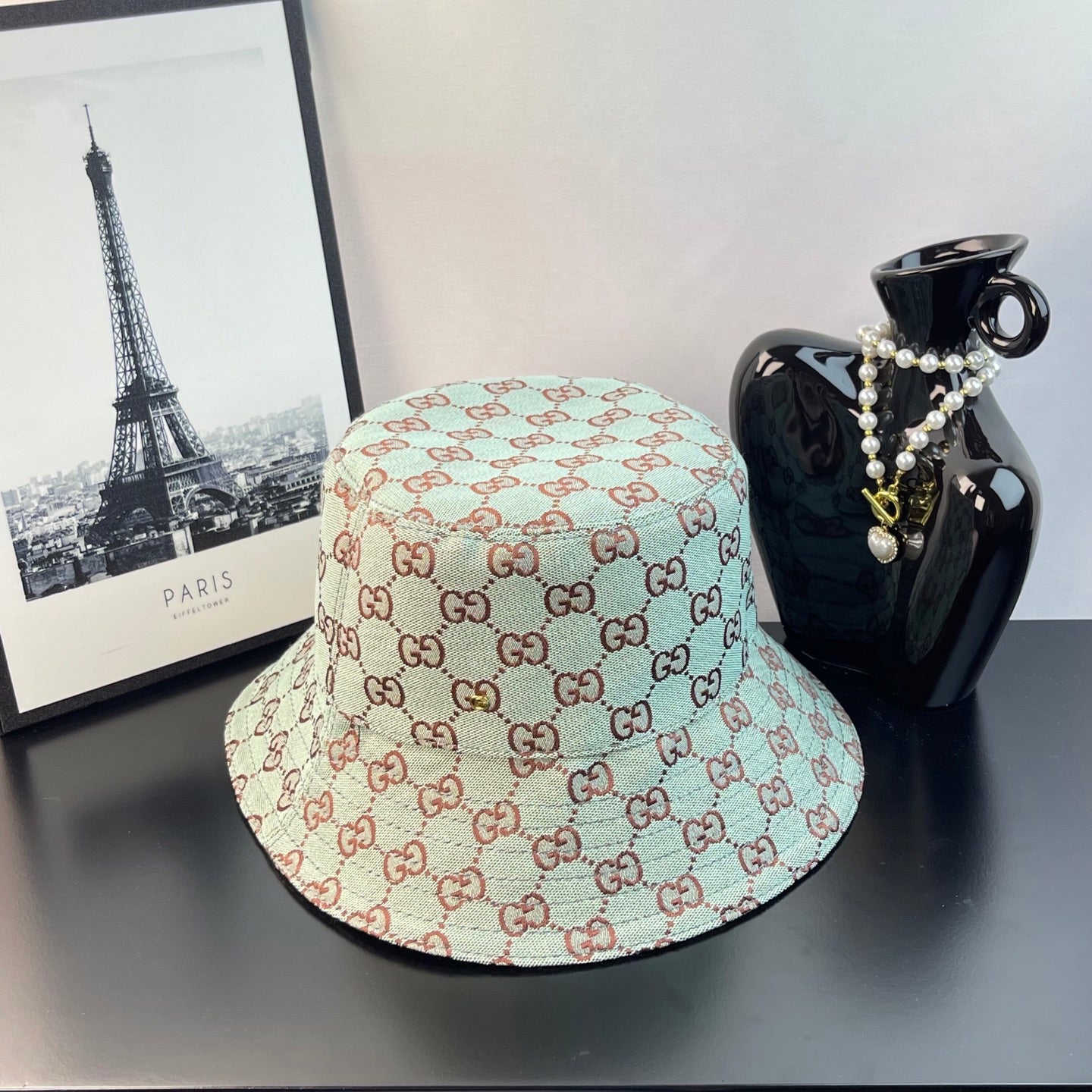 Bucket cap with GG monogram pattern, light teal and cream with red-brown accents