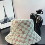 Bucket cap with GG monogram pattern in teal and cream with red-brown outline