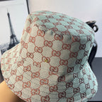 Bucket cap close-up with GG monogram weave pattern in teal and cream with red-brown
