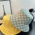 Gucci caps, one yellow GG and one teal GG with overlapping brims