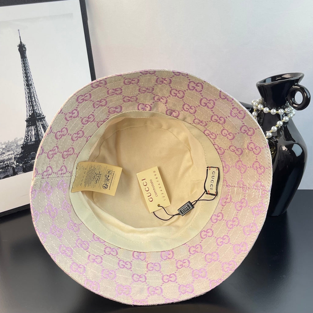 Gucci GG monogram bucket hat showing tan interior lining and hanging tags