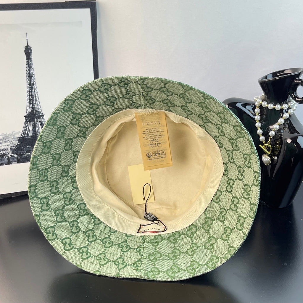 Gucci GG monogram bucket hat with light green patterned exterior and cream inside