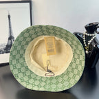 Gucci GG monogram bucket hat with light green patterned exterior and cream inside