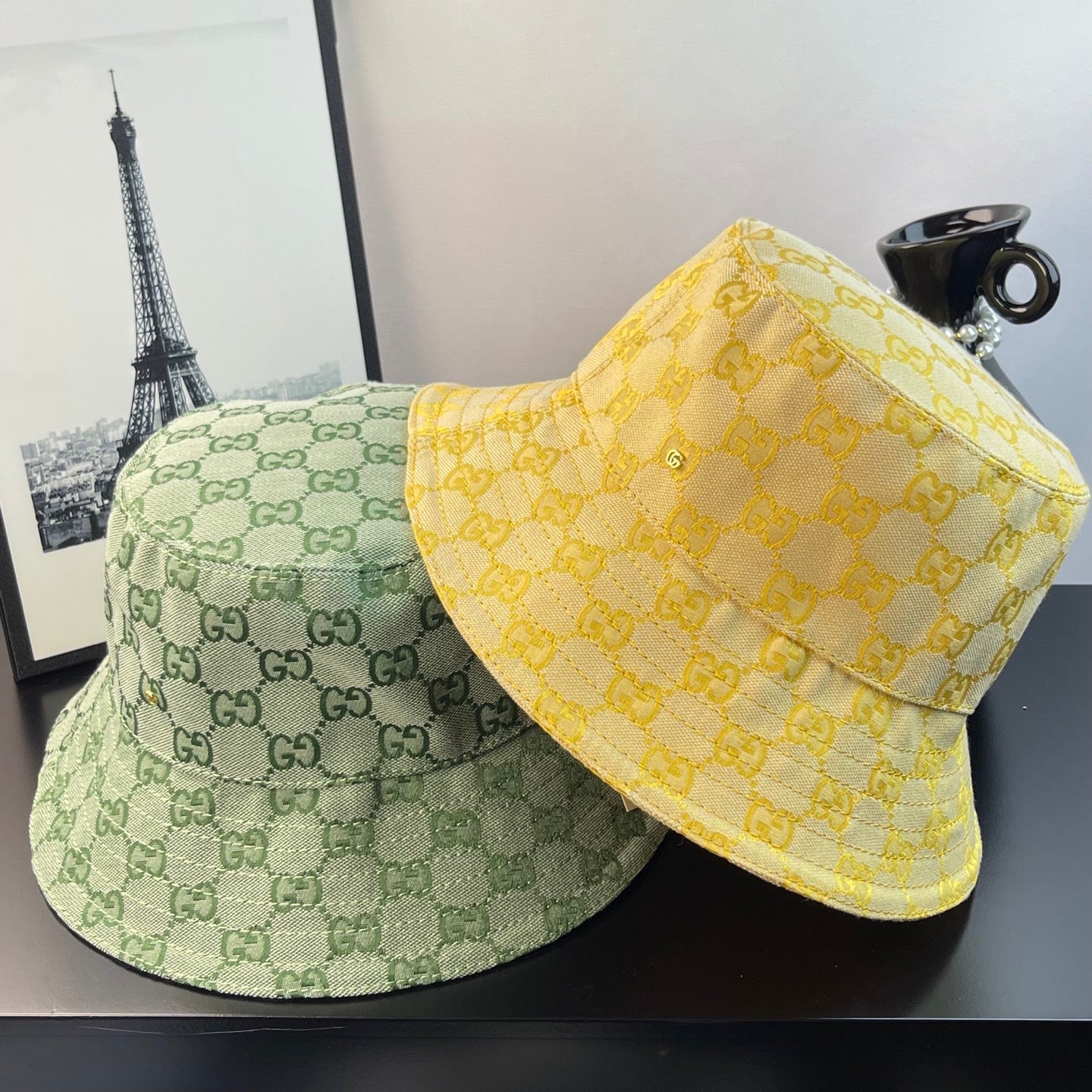 Gucci GG monogram bucket hats: light green and bright yellow with all-over pattern