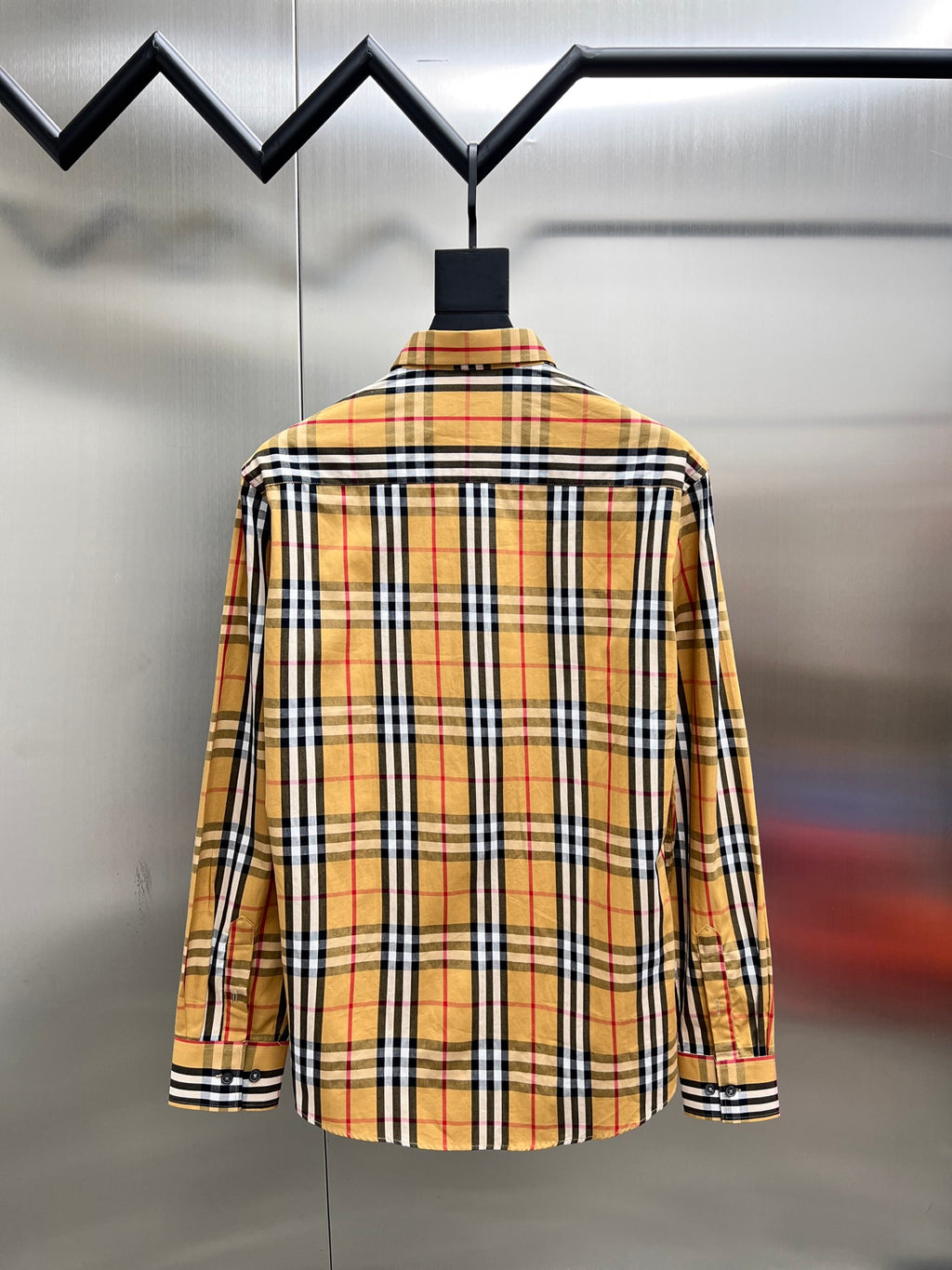 Plaid button-up shirt with long sleeves, back view with collar and button placket