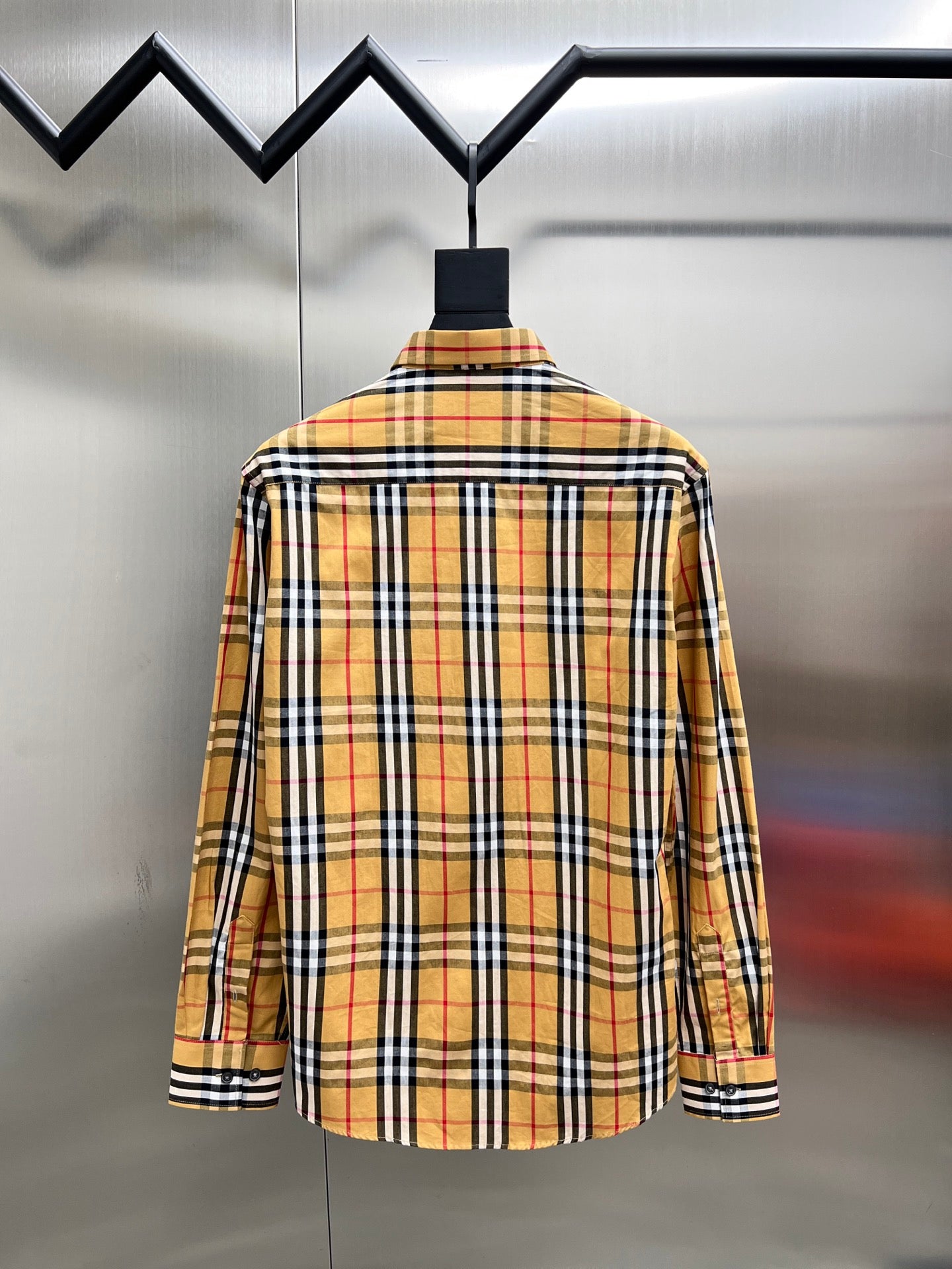 Plaid button-up shirt with long sleeves, back view with collar and button placket