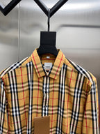 Plaid button-up shirt collar with front buttons and brand label at chest
